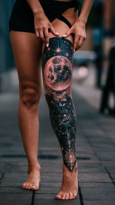 a woman is standing on the sidewalk with her leg covered in stars and moon tattoos