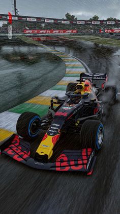 a red and yellow race car driving on a wet track