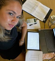 a woman sitting in front of a laptop computer