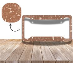 an empty license plate frame on a wooden table with a speech bubble in the middle