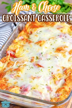 a casserole dish with ham and cheese in it on a wooden table next to some parsley