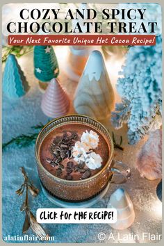 a bowl of hot chocolate with marshmallows and whipped cream in it on a table