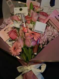 a bouquet of pink flowers and other items