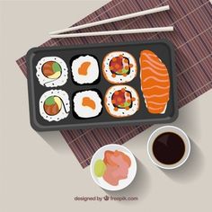 an overhead view of sushi and chopsticks on a tray with dipping sauce