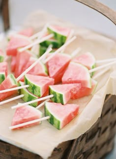 watermelon slices on sticks with toothpicks in them