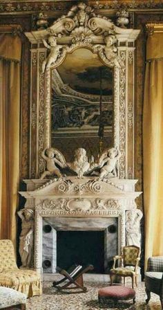 an ornate fireplace in the middle of a living room