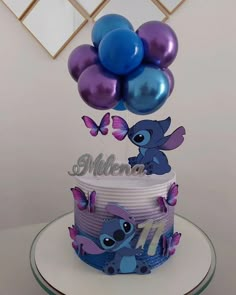 a birthday cake that has some balloons on it