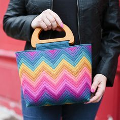 Where'd you get that amazing bag?! Stitch a bargello tote that's destined to become a wardrobe favorite with the all new Hello Bargello Dreamweaver Chevron Tote. We are just obsessed with this gorgeous new design and its fun, bold pattern. The details are stunning, from the boxed corners to the wooden handles - she's so worth the hours you'll spend stitching her, and she's sure to become a favorite bag for years. This tote is worked on plastic canvas and features sturdy wooden handles and a magn Plastic Canvas Bags, 70s Needlepoint, Plastic Canvas Bag, Bag With Wooden Handles, Yarn Tote Bag, Modern Needlepoint, Canvas Tapestry, Mini Booklet, Yarn Embroidery