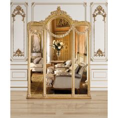 an ornately decorated mirror in the middle of a room with couches and chairs