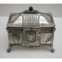 an antique silver jewelry box with ornate decoration