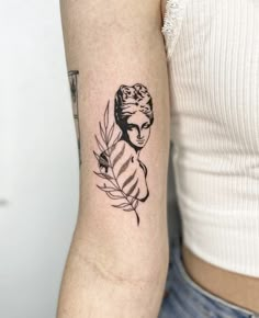 a woman with a feather tattoo on her arm