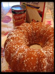 a bundt cake sitting on top of a table next to a can of food