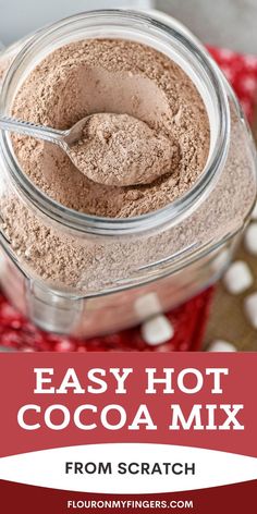 closeup photo of a spoonful of easy homemade hot cocoa mix over a glass jar full of hot cocoa mix