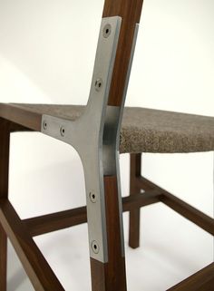 a wooden chair with metal frame and seat padding on it's back end