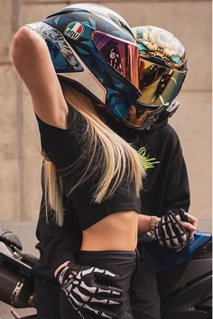 a woman with her hand on the back of a motorcycle