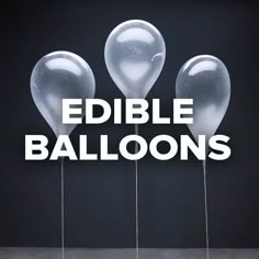 three clear balloons with the words edible balloons in white letters on them, against a black background