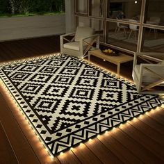 a black and white area rug with lights on the floor in front of a window