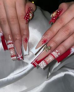 These long square nails showcase a bold red and white pattern with holiday details like snowflakes and knit textures. A gold bow accent on one nail adds a festive touch, making it perfect for the holidays. This look is great for those who love detailed and playful sweater art designs. Christmas Nails Decor Ideas, Cute Long Christmas Nails, Christmas Long Nail Designs, Winter Nails Long Square, Red Christmas Sweater Nails, Red Bling Christmas Nails, Christmas Nail Inspo 2024, Christmas Nails2024, Red And Gold Christmas Nails Acrylic