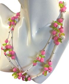 Charming 1950's flower and tube shaped lucite bead single strand necklace.  Unsigned.  Shown doubled but is a single strand with no closure, just slip over your head.  Smaller beads giving the necklace a more delicate, demure appearance.  Pink flowers, green leaves and white tube beads.   In very very good condition.  36" long.  We welcome your inquiries. Green Flower-shaped Beaded Necklace With Colorful Beads, Pink Flower-shaped Necklace With Flower Decoration, Green Flower-shaped Beaded Necklace, Vintage Flower-shaped Beaded Necklaces, Pink Flower-shaped Necklaces With Colorful Beads, White Tube, Flowers Green, Tube Beads, Strand Necklace