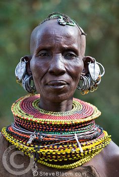 an african woman with ear rings on her head