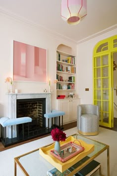 a living room filled with furniture and a fire place in front of a book shelf