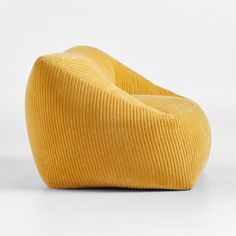 a yellow chair sitting on top of a white floor