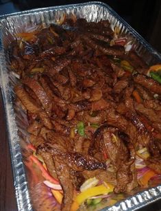 meat and vegetables are being cooked in foil