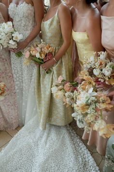 a bride poses with her bridesmaids who are dressed in warm tone, floor length dresses and pastel bouquets Shades Of Yellow Bridesmaid Dresses, Mismatching Bridesmaid Dresses, Pink And Yellow Bridesmaid Dresses, Pastel Bridesmaid Dresses Mismatched, Pastel Wedding Guest Dress, Butter Yellow Wedding, Yellow Bridesmaid Dresses Mismatched, Color Bridal Bouquet, Pastel Yellow Bridesmaid Dresses