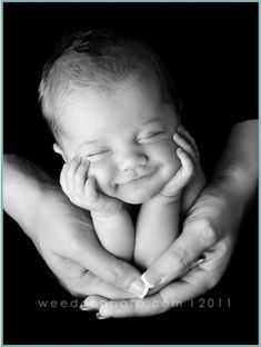 a black and white photo of a baby in its mother's hands with the caption welcome home 2011