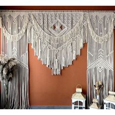 there is a wall hanging made with macrame and tassels on it