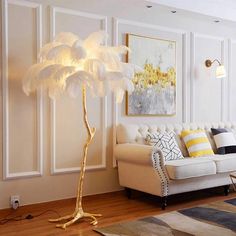 a living room filled with furniture and a large feather lamp on top of a wooden floor