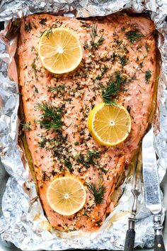 baked salmon with lemons and herbs on foil