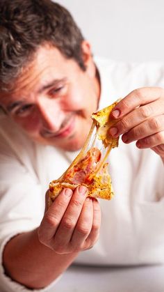 a man is eating a slice of pizza