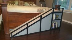 a bed with a book shelf under it in a bedroom next to a wooden floor