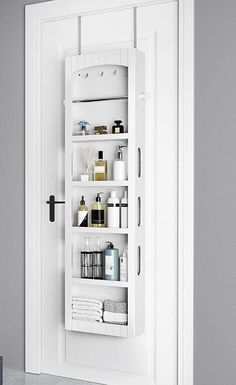 the door is open and there are many items on display in this white bathroom cabinet