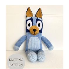 a knitted blue and white stuffed animal sitting on top of a table with the words knitting pattern below it