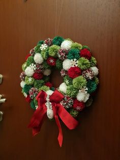 a christmas wreath hanging on the door