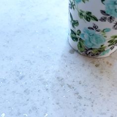 a coffee cup sitting on top of a white counter