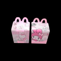 two pink hello kitty boxes on black background