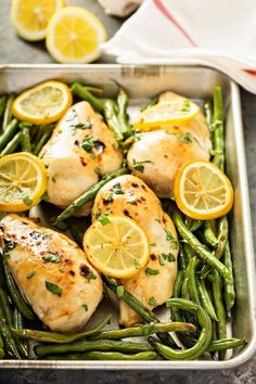 chicken and green beans in a pan with lemons