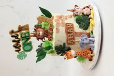 a cake decorated with animals and letters