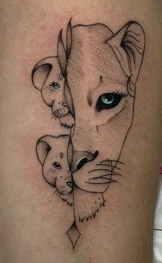 a lion and cub tattoo on the thigh