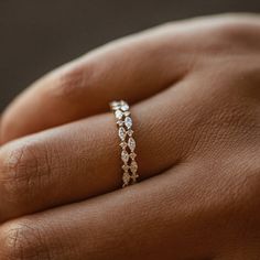 a woman's hand with a diamond ring on it