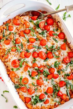 a casserole dish filled with tomatoes and cheese