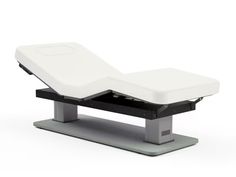 a white and black bed sitting on top of a metal stand with the mattress attached to it