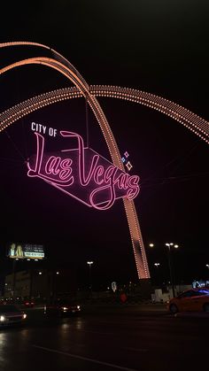 the city of las vegas sign is lit up at night with lights on it's sides