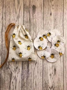 the bees are printed on white fabric with brown leather straps and matching plates in front of it