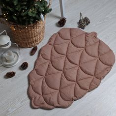 a potted plant sitting on top of a wooden floor next to a pink rug