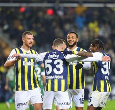 a group of men standing on top of a soccer field