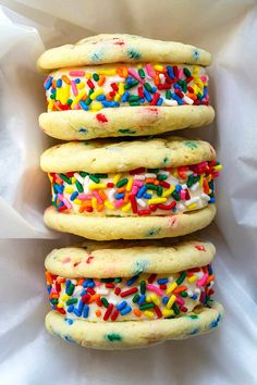 three cookies with sprinkles are stacked on top of each other